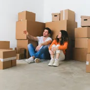 Couple in front of boxes, imagining the future